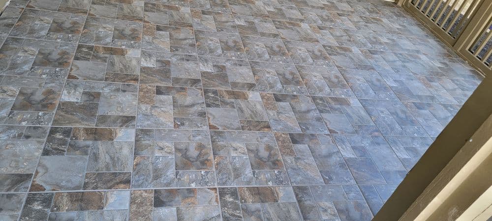 Modern gray tiled flooring with a geometric pattern, ideal for outdoor and indoor spaces.