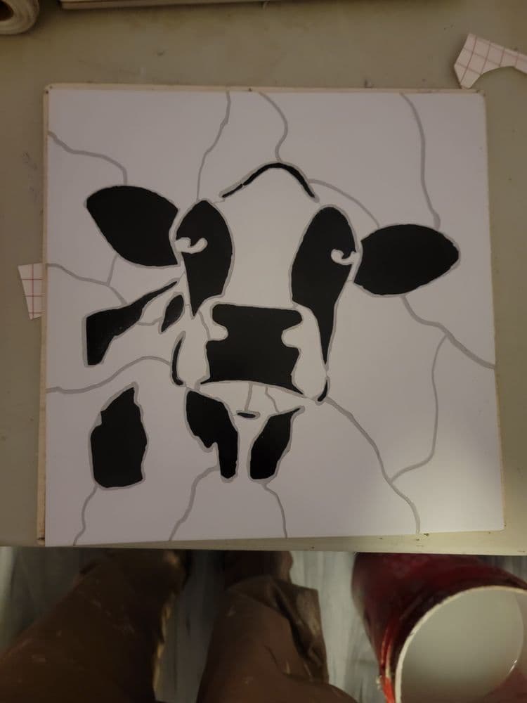 Black and white cow silhouette artwork with cracked background design.