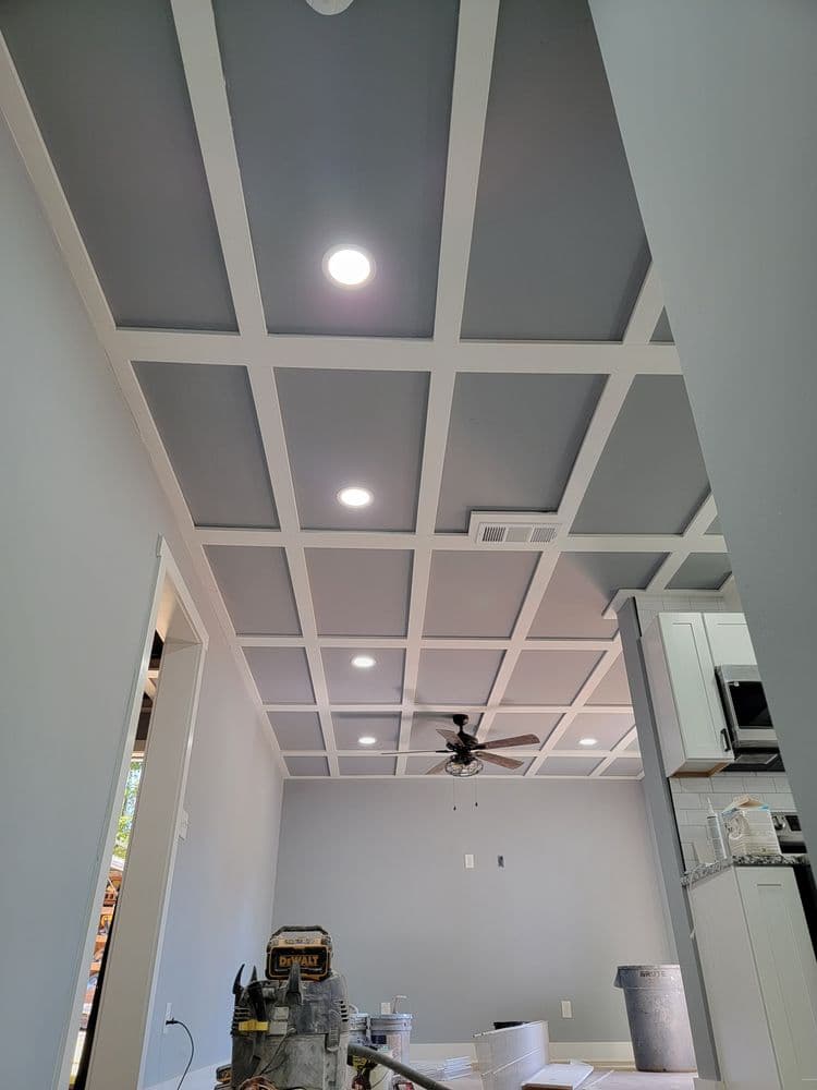 Modern coffered ceiling with recessed lights in a freshly painted kitchen interior.