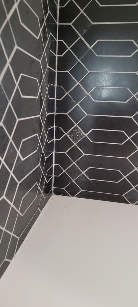Geometric black and white tiled corner with clean lines and modern design.