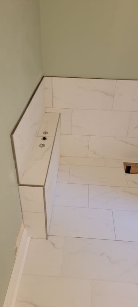 Modern bathroom featuring marble tile flooring and a sleek, minimalist design.