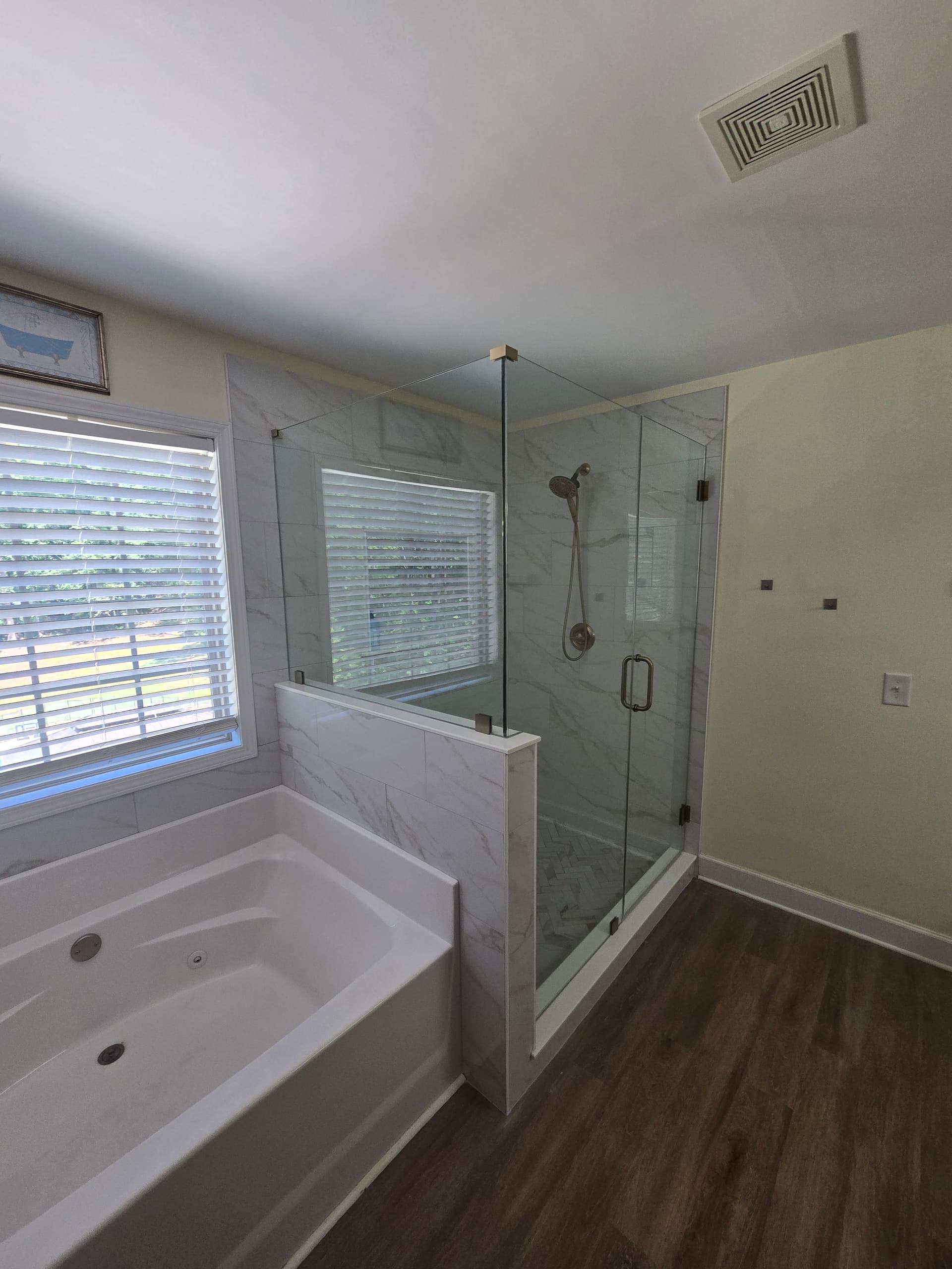 Shower Renovation with Champagne Bronze Fixtures and Marble Tile image