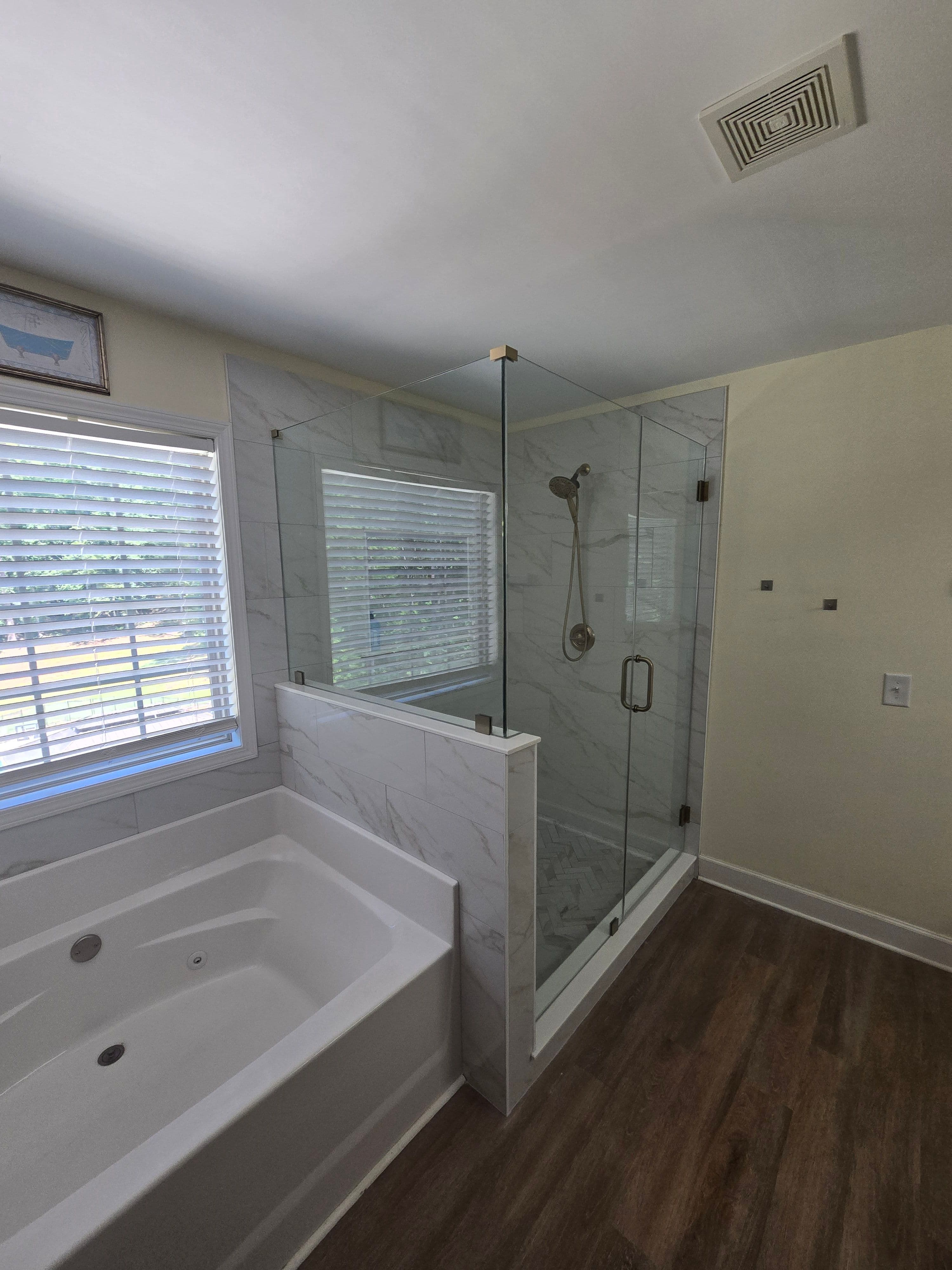 Project Shower Renovation with Champagne Bronze Fixtures and Marble Tile image