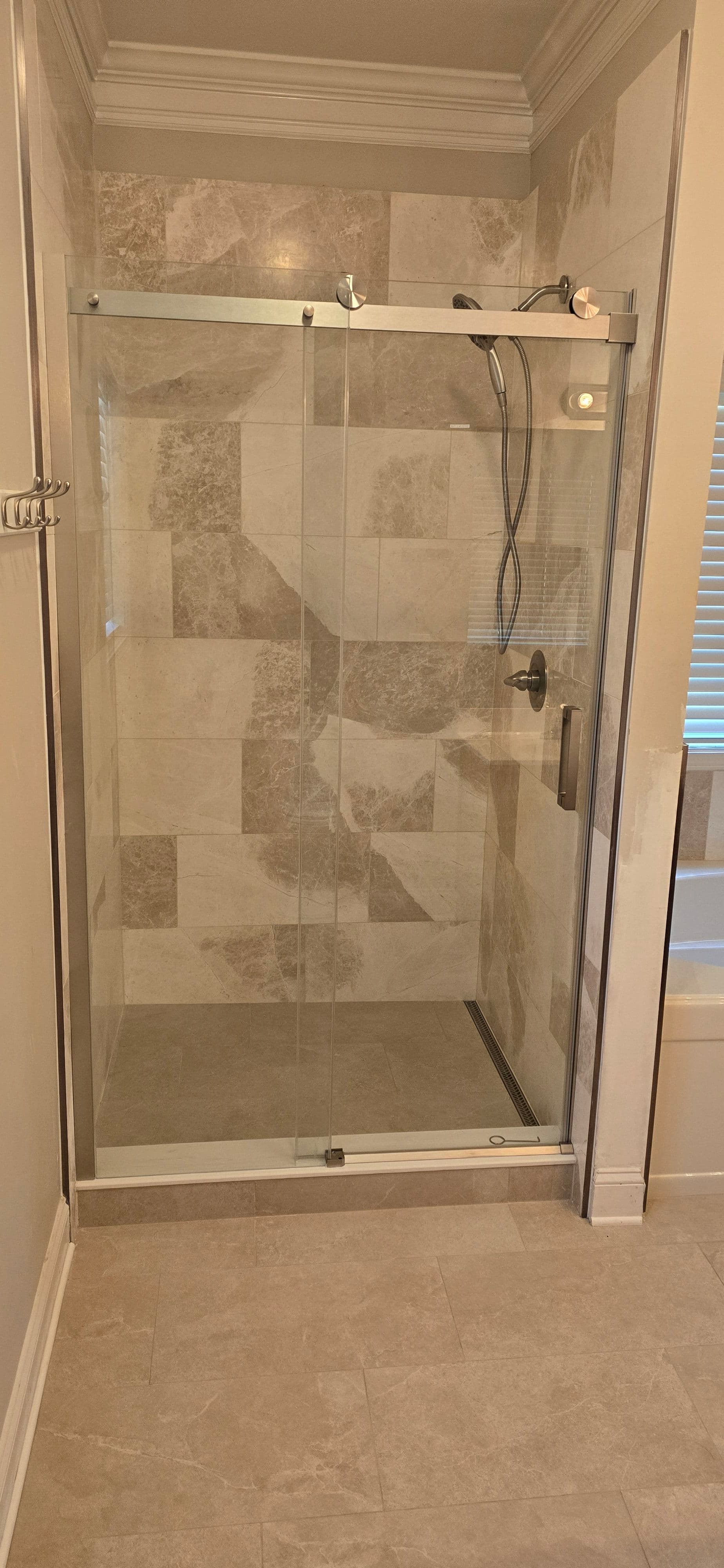 Marble-Style Bathroom Renovation with Frameless Glass Shower image